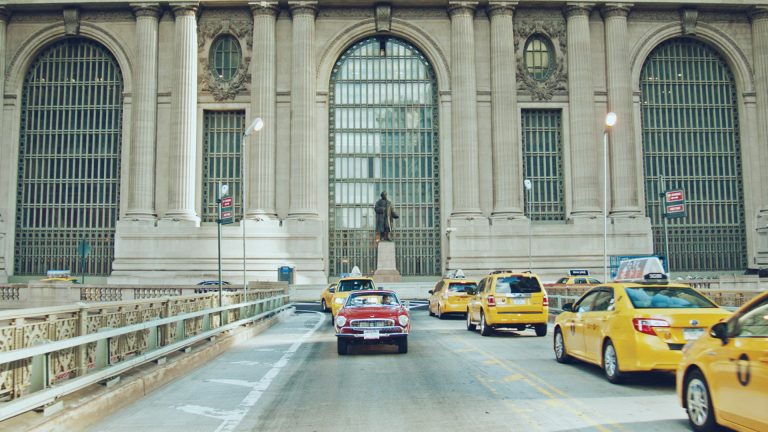 Shot of Irv Gordon driving his 3 million mile car in front of Grand Central Station, New York.